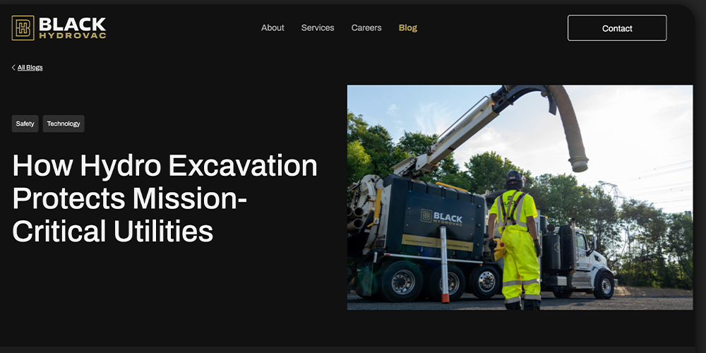 Worker in hi-vis operates hydro excavation truck under clear sky.