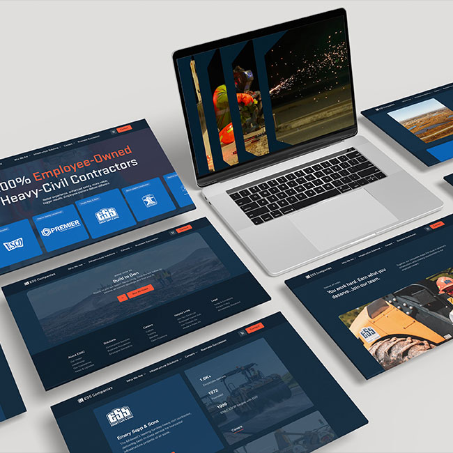Laptop and website mockups for a civil contractor on light surface.