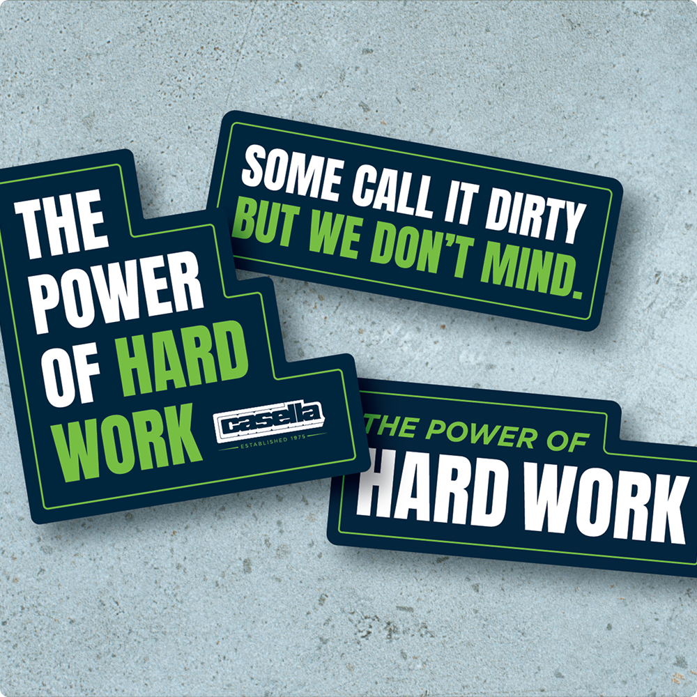 Three stickers on concrete say THE POWER OF HARD WORK.