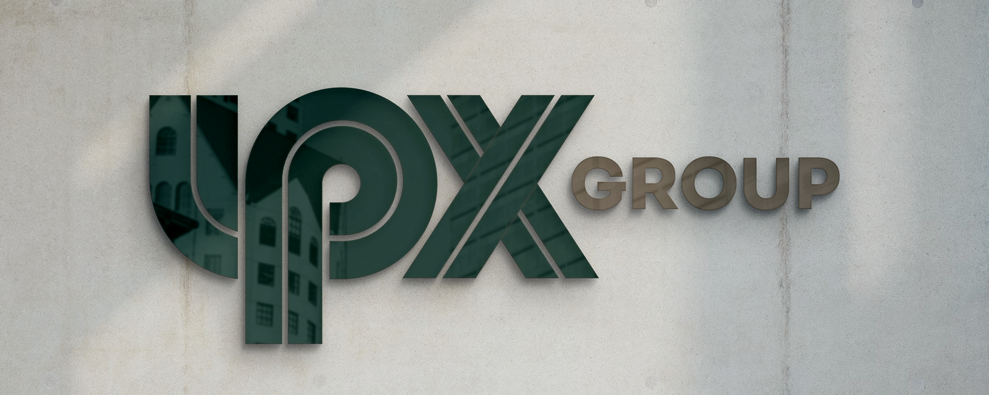 Wall sign reads UPX in green, GROUP in brown.