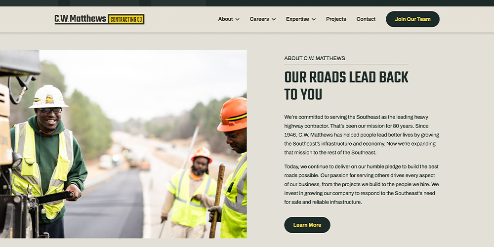 Construction workers build road as sidebar shows company commitment.