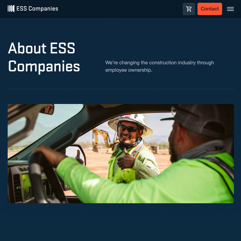 Two construction workers talk near a truck; one gives thumbs up.