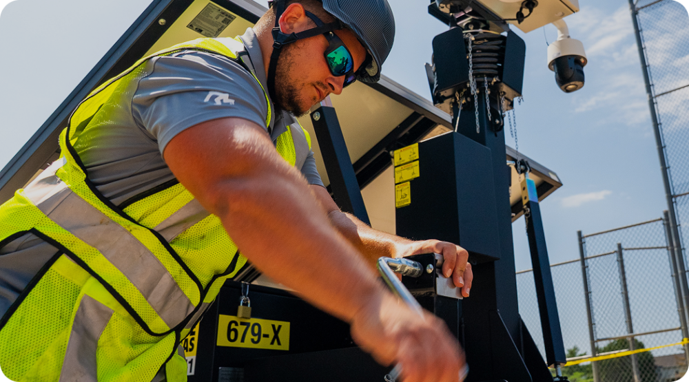 Employee for 24/7 Onsite Camera working on equipment in safety gear.