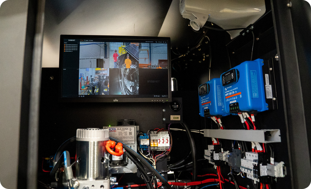 TVs showing camera footage from 24/7 Onsite Security cameras on a jobsite.