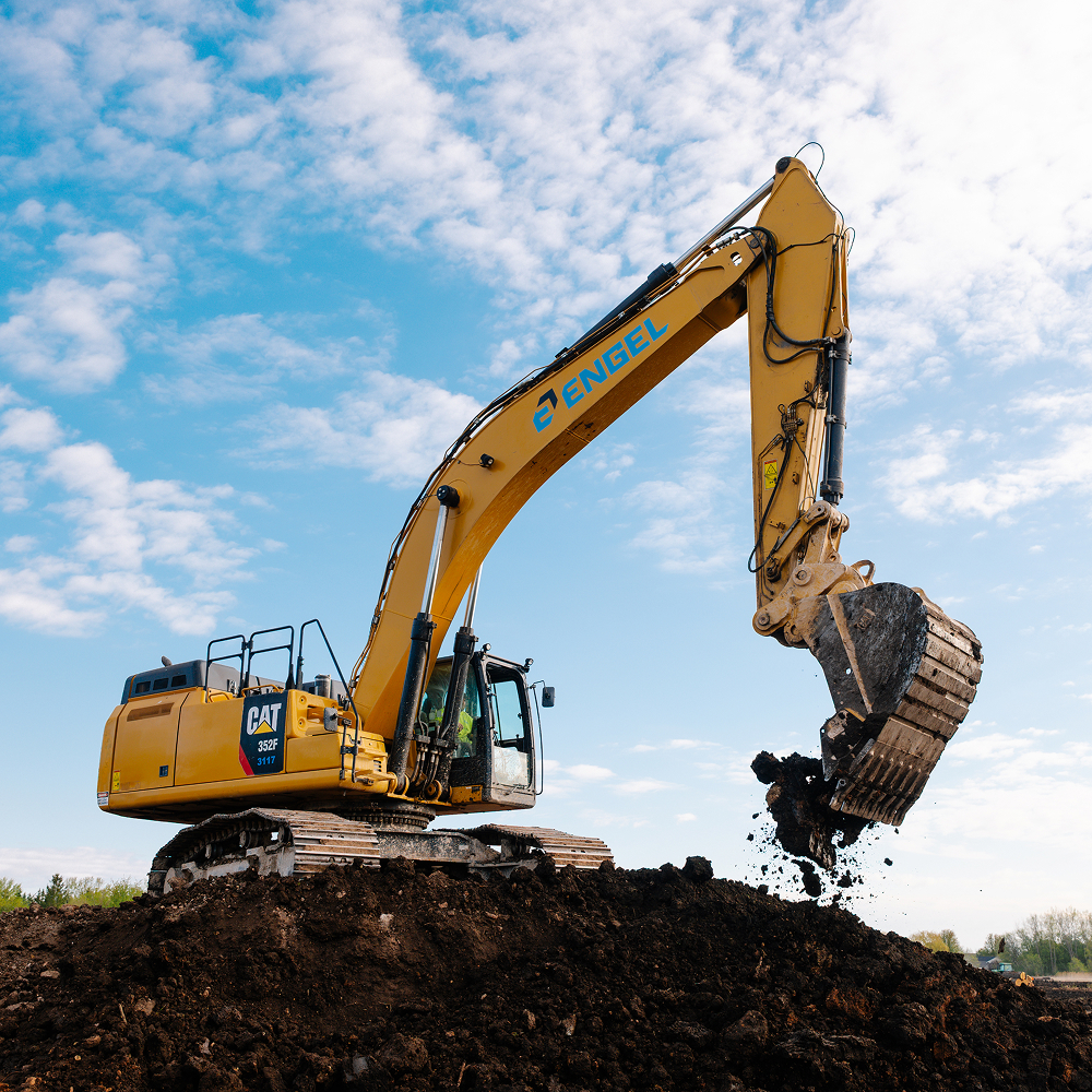 yellow excavator moving dirt