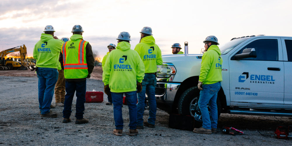engel excavating employees having a meeting on a job site